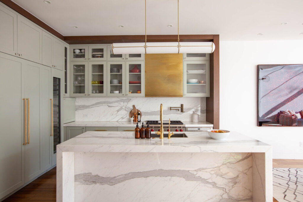 A beautifully laid out kitchen with a marble kitchen island making it a multifunctional space.