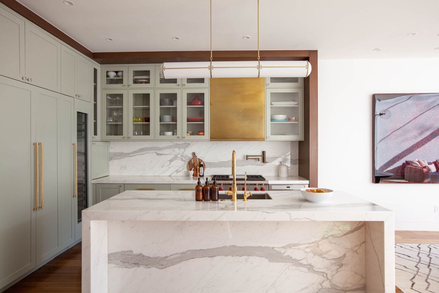 Luxury Kitchen Renovation with marble countertops and gold faucet accents.