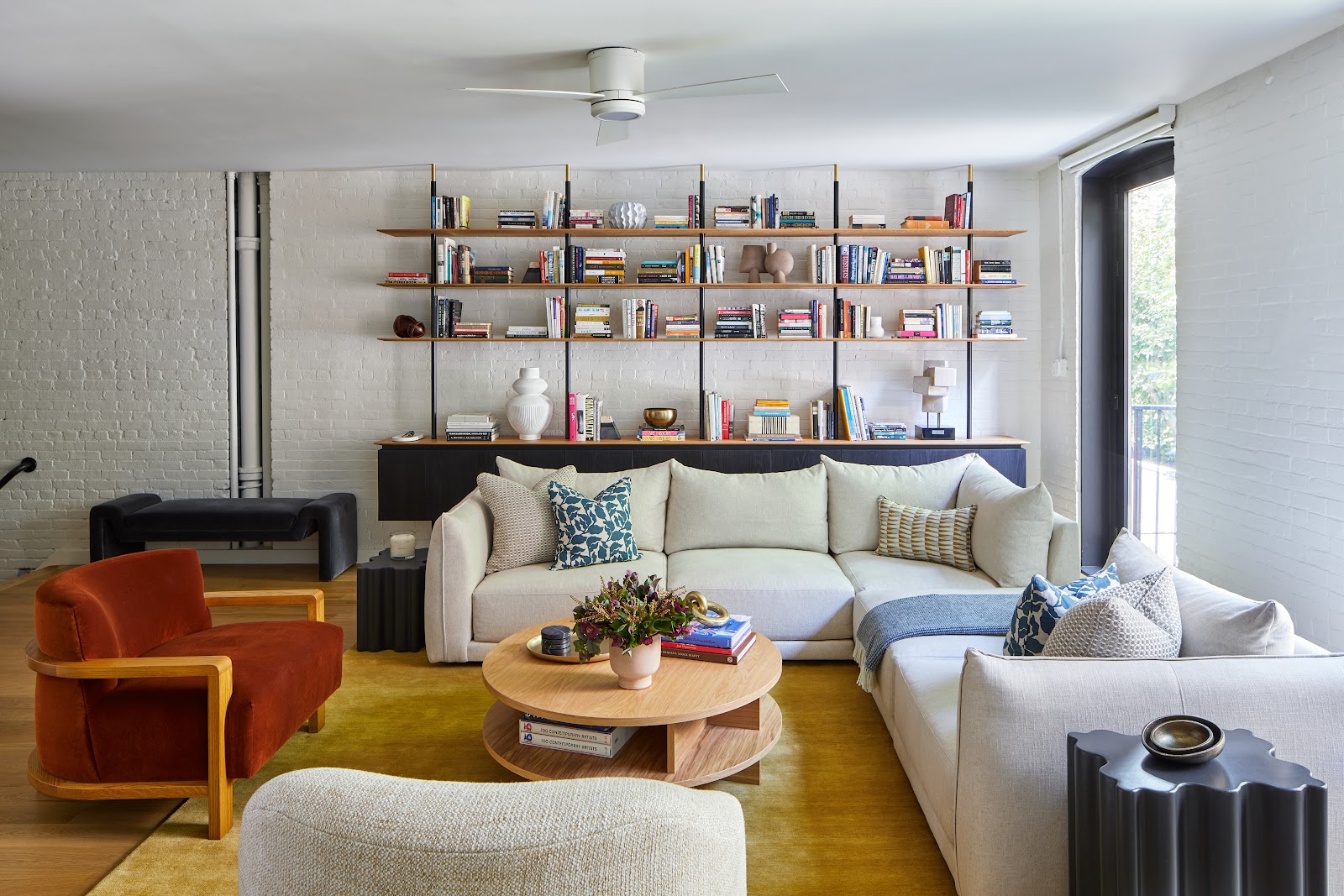 Living room space with wall bookshelf and natural lighting.