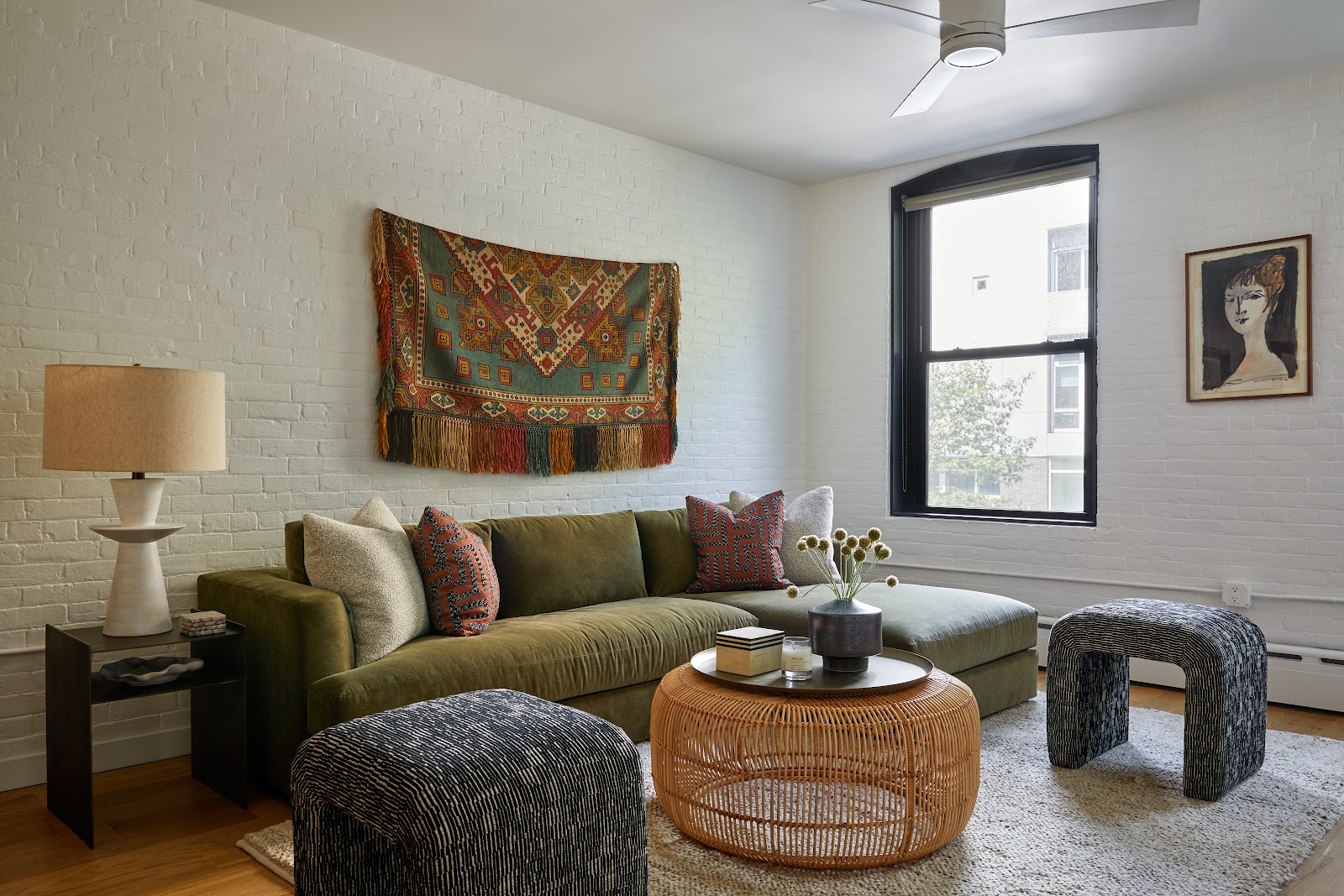 Living room area with natural and rustic colors, primary olive sofa with rustic center table.