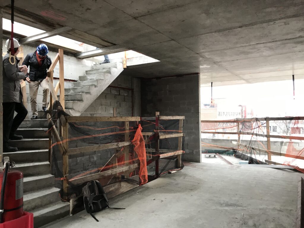 Construction workers building a family-friendly living room with modern, durable design elements.